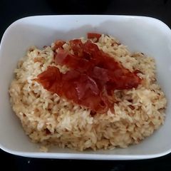 A picture of Riso Carnaloni Al Parmigiano con Bacon croccante e pepe in grani.