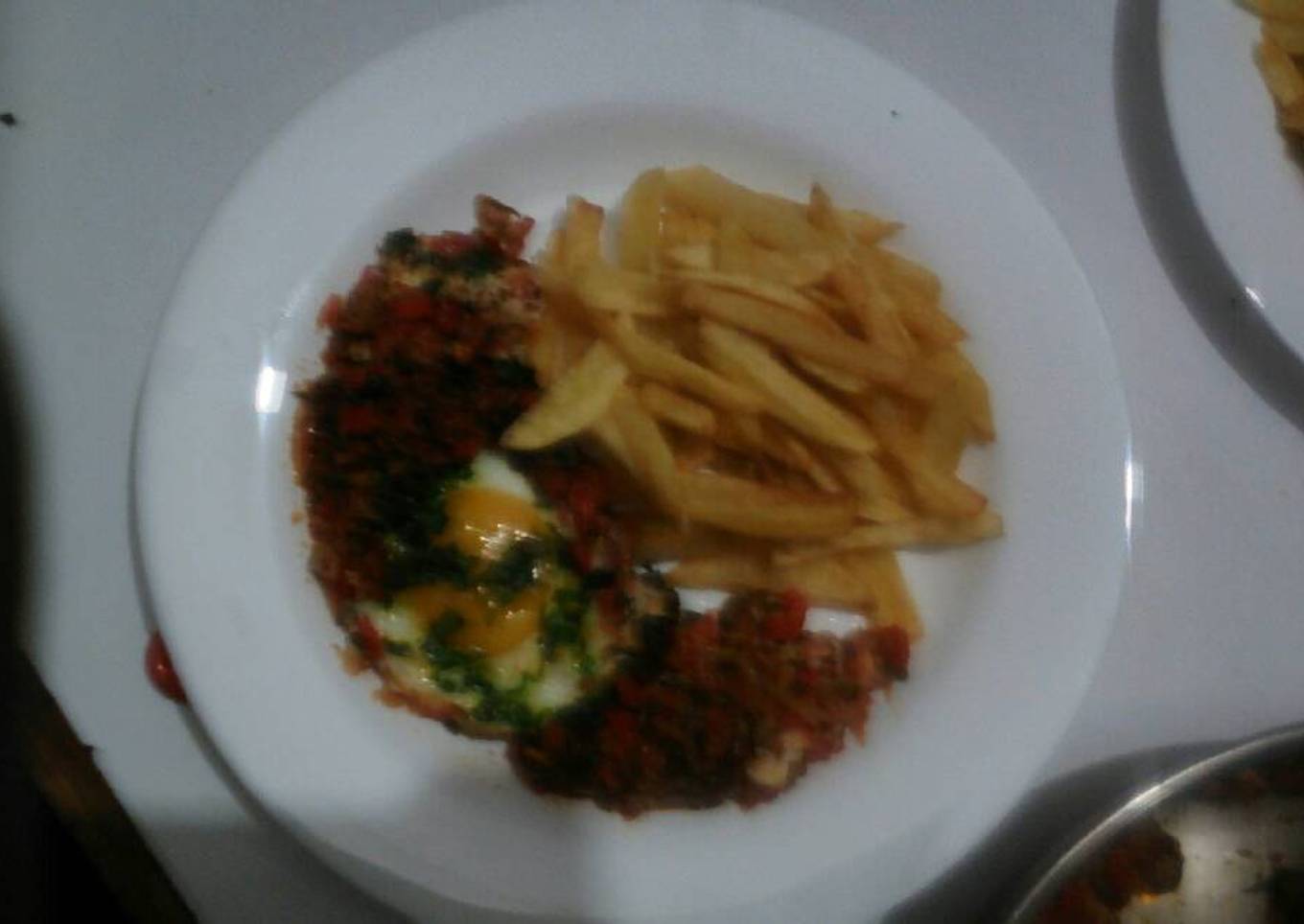 Shakshuka accompanied by French fries