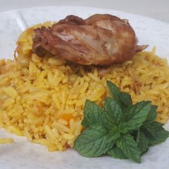 A picture of Fried rice with fried chicken.