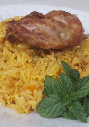 A picture of Fried rice with fried chicken.