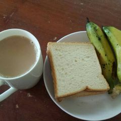 Breakfast Triple Combo(Tea, banana & Bread) A picture of Breakfast Triple Combo(Tea, banana & Bread).