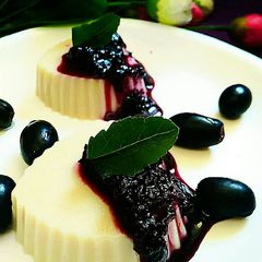 A picture of White chocolate panna Cotta with blueberry sauce.
