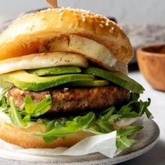 A picture of Chicken, Red Pepper & Feta Burger with Avo & Halloumi.