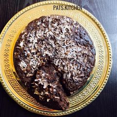 A picture of Chocolate cake with Coconut shavings.