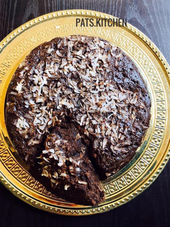 A picture of Chocolate cake with Coconut shavings.