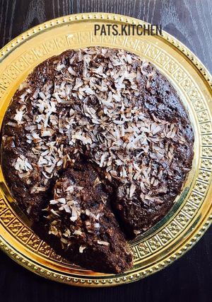 A picture of Chocolate cake with Coconut shavings.