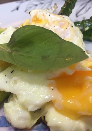 A picture of Asparagus with fried eggs.
