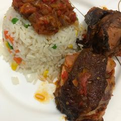 A picture of Roasted chicken sauce and garnished rice.