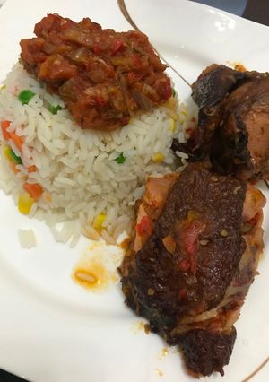 A picture of Roasted chicken sauce and garnished rice.