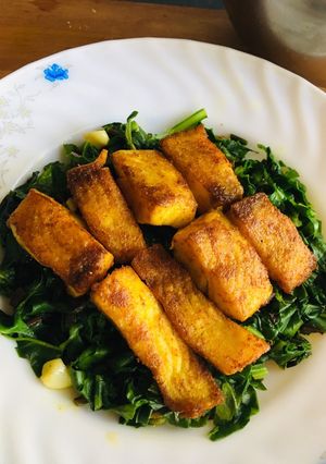 A picture of Fried fish with garlic flavour spinach.