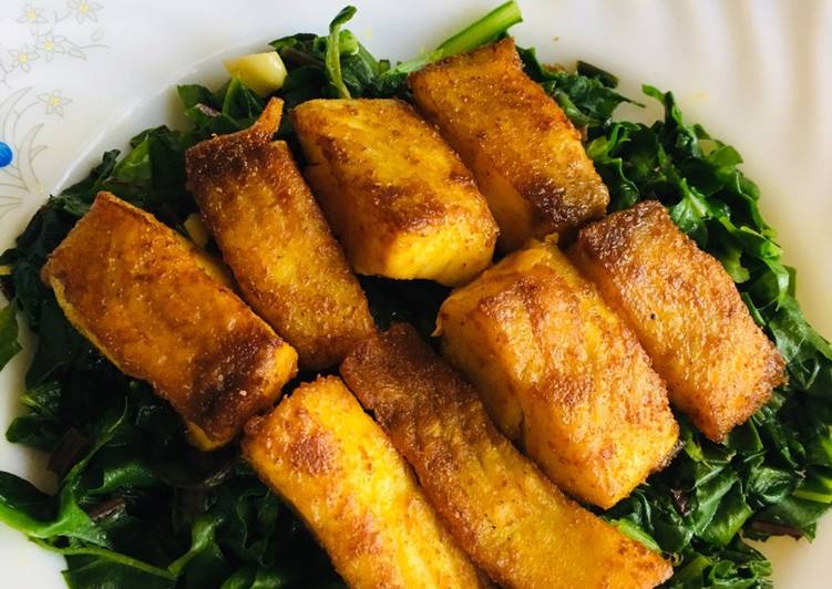 Fried fish with garlic flavour spinach