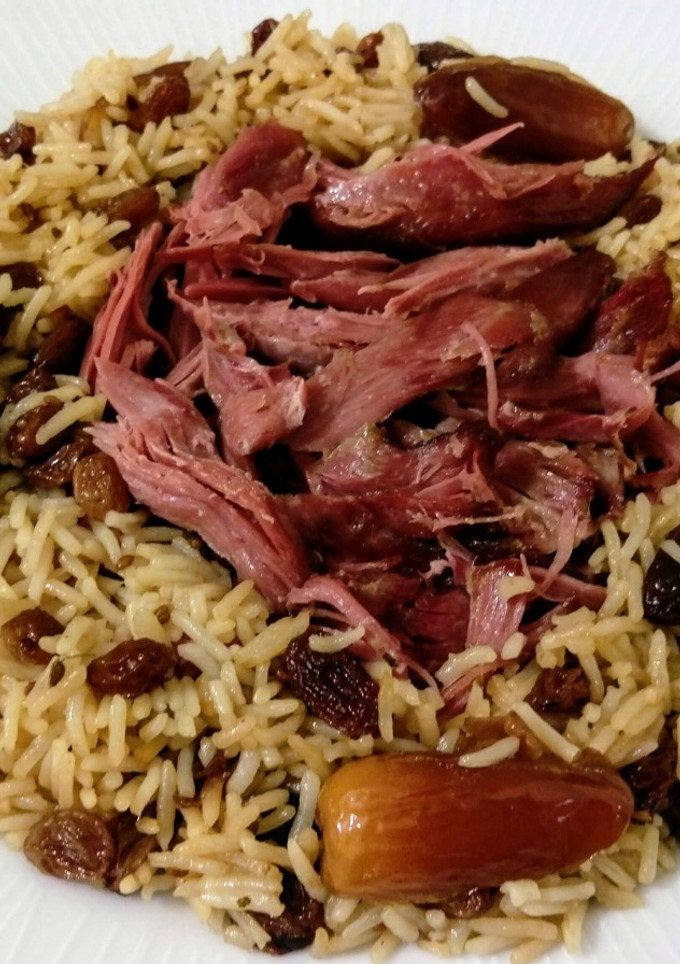 Una foto de Arroz con pato, anís y frutos secos