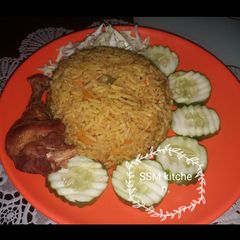 A picture of Fried rice with fried chicken.