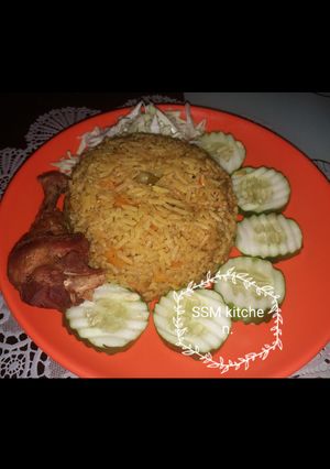 A picture of Fried rice with fried chicken.
