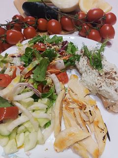 A picture of Sliced Chicken Breast with Mixed Salad and Toasted Bread with Avocado Yogurt Spread.