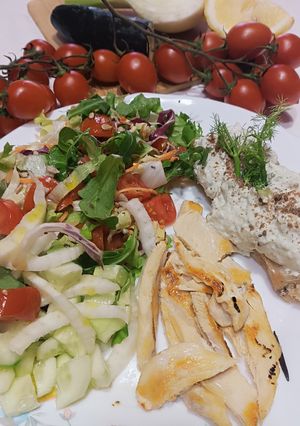 A picture of Sliced Chicken Breast with Mixed Salad and Toasted Bread with Avocado Yogurt Spread.