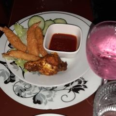 A picture of Panko crumbed prawns and sticky drummy.