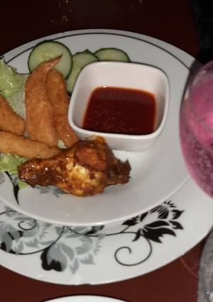 A picture of Panko crumbed prawns and sticky drummy.