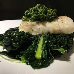 A picture of Roasted cod with cavolo nero and salsa verde.