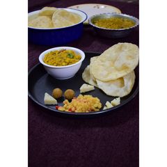 A picture of Luchi cholar dal(Bengal gram dal and puri).