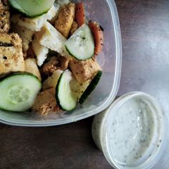 A picture of Greek-inspired salad bowl with paneer souvlaki.