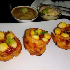 A picture of Creamy tandoori momos with hot broccoli sauce.