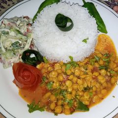 A picture of Chana daal fry with garlic rice.