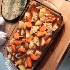 A picture of Potato and carrot in gravy.