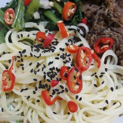 A picture of Spicy spaghetti and bbq pattie.