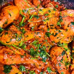 A picture of Drooling chicken leg pieces with gravy.
