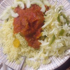 A picture of Rice n veggies with stew.
