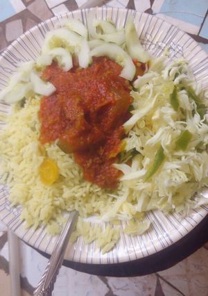 A picture of Rice n veggies with stew.