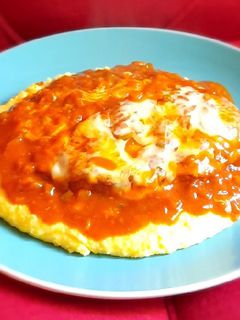 Una foto de Pollo a la parmesana y polenta