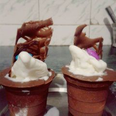 A picture of Chocolate cups with ice cream.