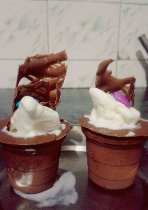 A picture of Chocolate cups with ice cream.