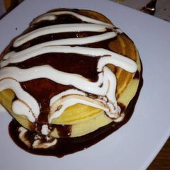 A picture of Pan cake with nutella and cream.