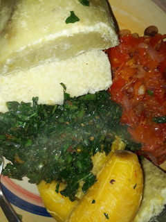 A picture of Boiled yam and plantain with sauce and vegetable.