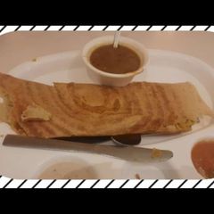A picture of Dosa with sambhar.