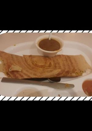 A picture of Dosa with sambhar.