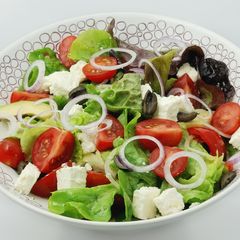 A picture of Greek salad with avocado.