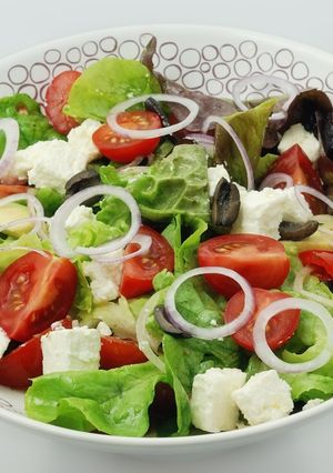 A picture of Greek salad with avocado.