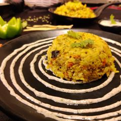 A picture of Vegetable khichdi with achari dip.
