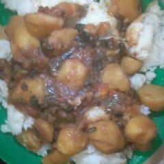 Stewed Irish potatoes served with plain rice A picture of Stewed Irish potatoes served with plain rice.