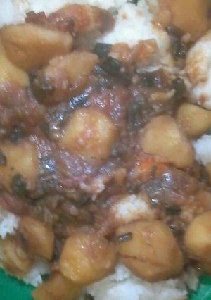 A picture of Stewed Irish potatoes served with plain rice.