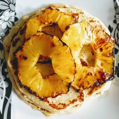 A picture of Banana Pancakes with Grilled Pineapple and Honey.