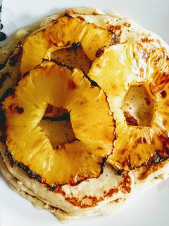 A picture of Banana Pancakes with Grilled Pineapple and Honey.