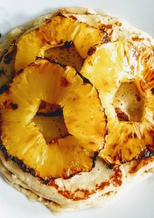 A picture of Banana Pancakes with Grilled Pineapple and Honey.