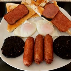 A picture of My filling Breakfast, Bacon Grill, Black pudding sausage + Eggs.