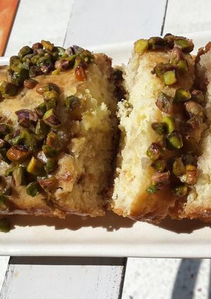 A picture of Orange and Rose Syrup Cake with Pista Crunch.