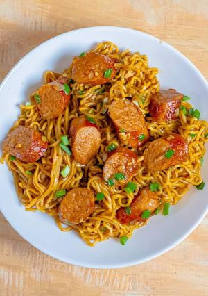 A picture of Indomie noodles and sausage.